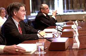 Chief Counsel Lewis Morris sitting at table